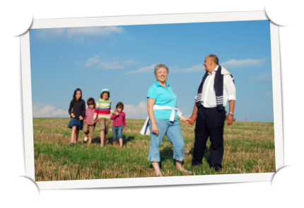 Family walking in a field of grass